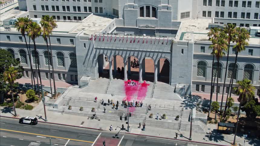 Fake blood and protesters on the steps of los angeles city hall