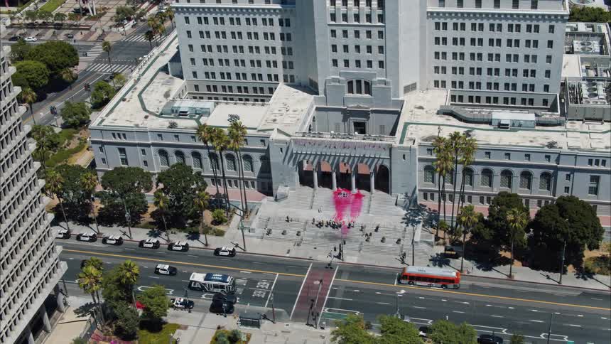 Protesters have spilled red paint down the steps of a building in a city