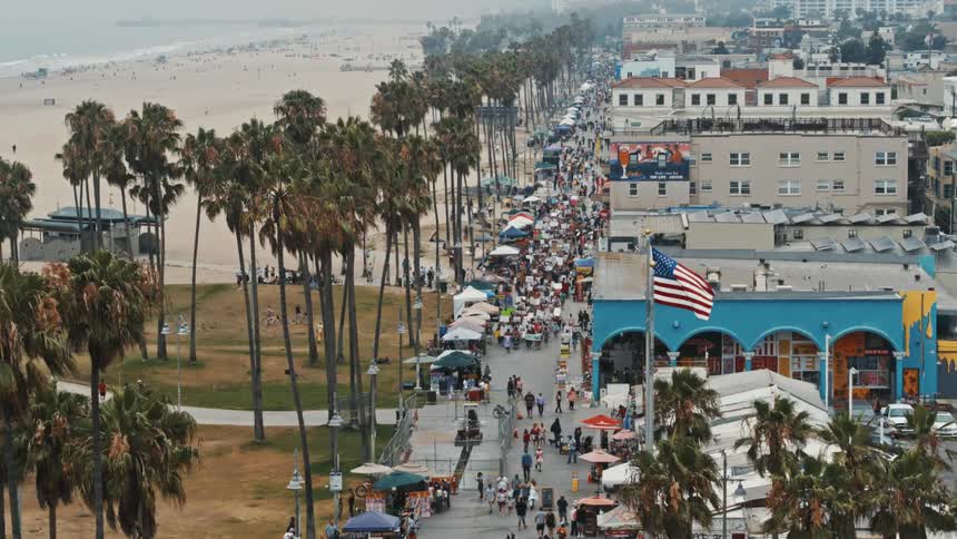 Aerial view of the crowded boulevard surrounded by palm trees on venice beach california at daytime