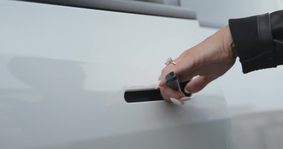 A person opens the door of the vehicle