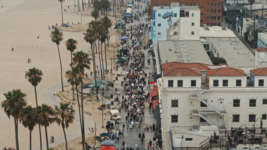 People are marching by the shoreline town