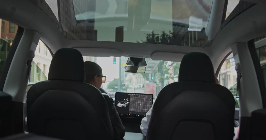A man and woman get into the front seats of their vehicle
