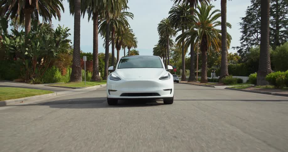 White sports car drives on city highway