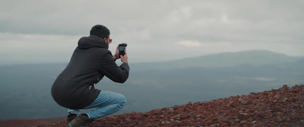 A man taking a photo outdoors