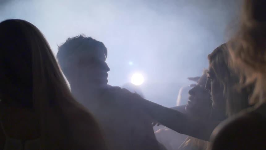 A man is being touched by women all around him