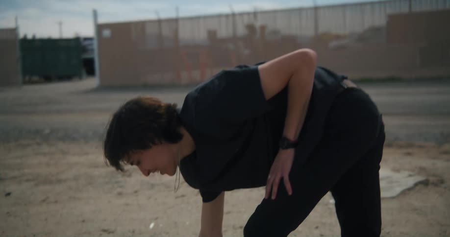 A boy jumps off the pile of rocks