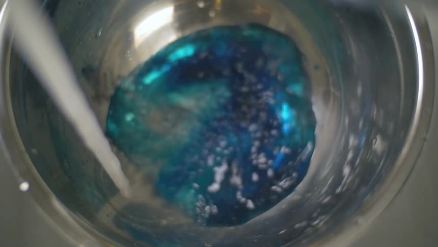 Water and dye filling a bowl