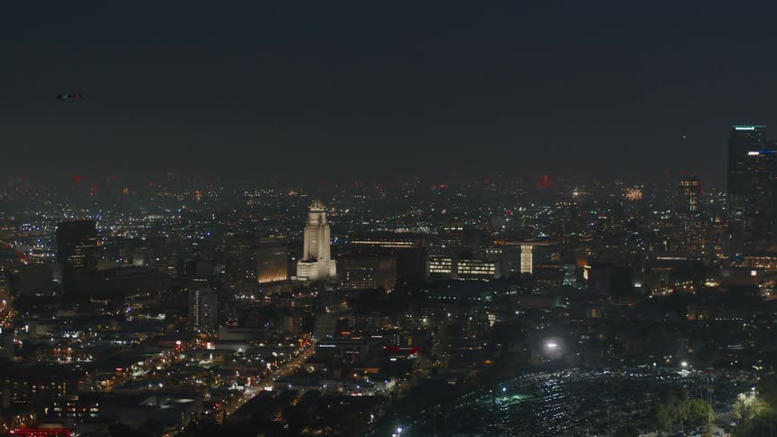 Fireworks are exploding all around Los Angeles City Hall at night