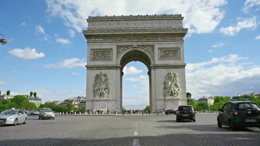 View of cars passing the Arc de Triomphe in Paris