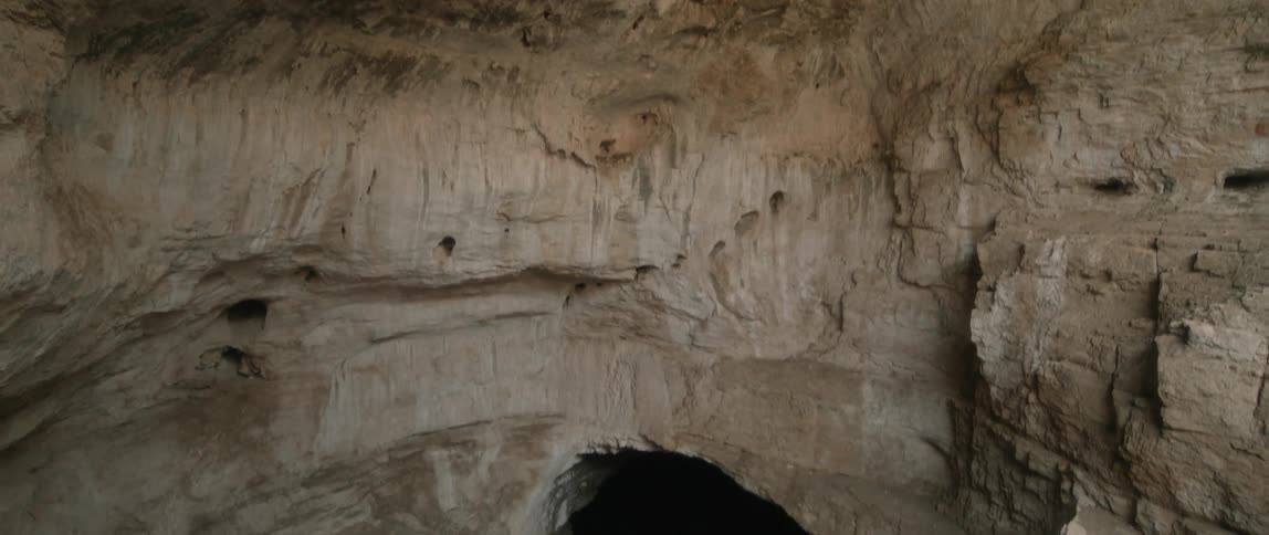 Aerial view of a cave is displayed during midday