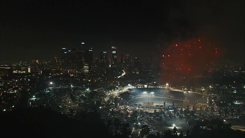 Aerial view of city football stadium and a fireworks display at night