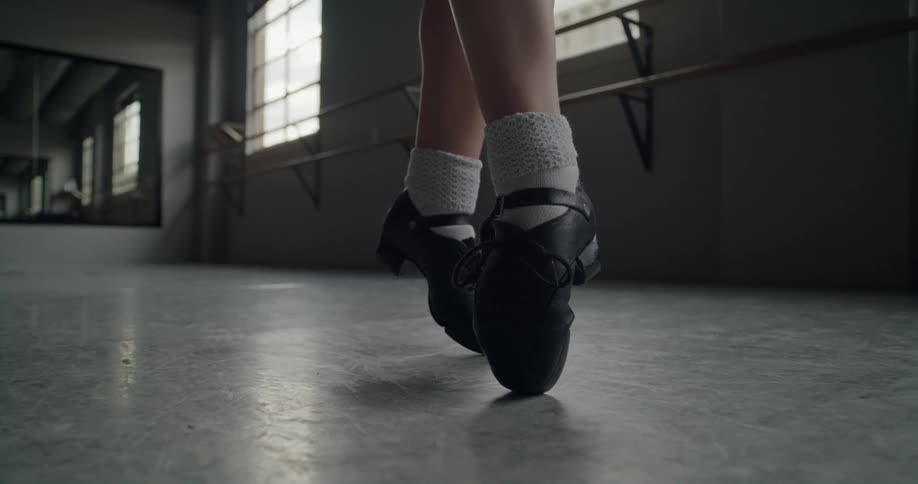 Close up of a ballerinas feet as she stands on her toes