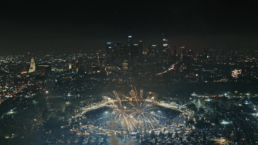 Aerial view of city football stadium and a fireworks display at night