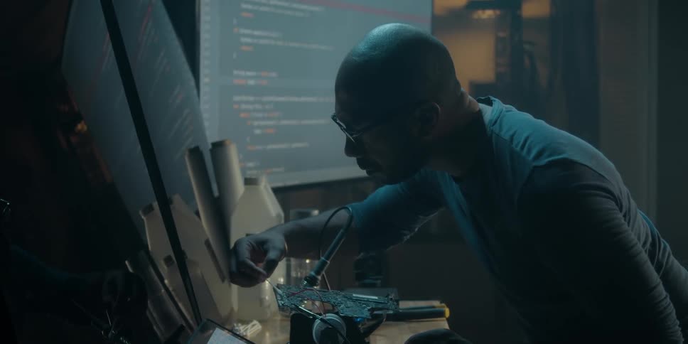 A man is cleaning a computer component with a cotton swab