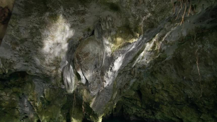 Reflected light shimmers on rocks in a lagoon in Tulum, Mexico