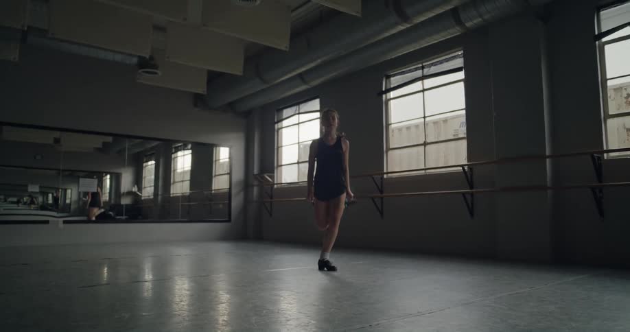 A girl is dancing in the hall