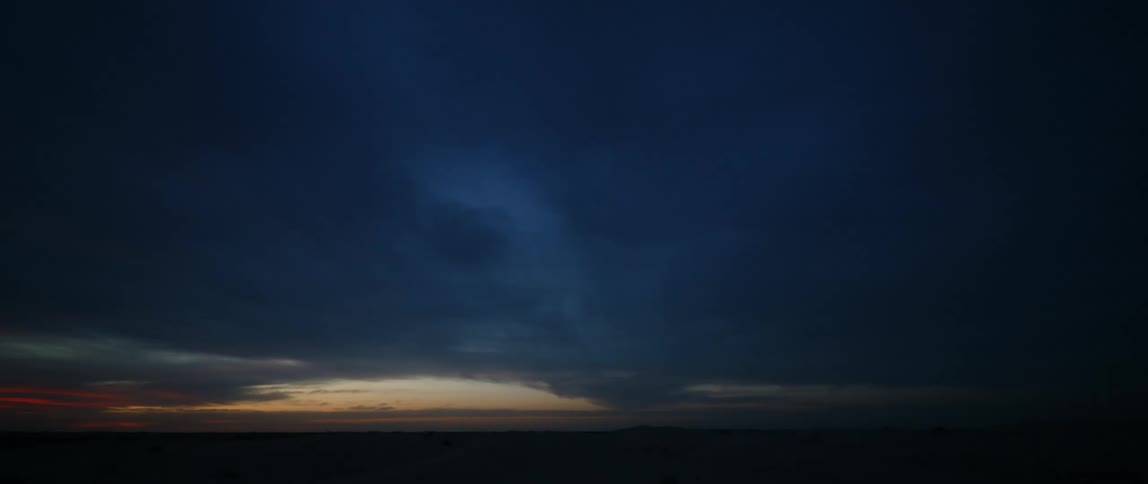 A landscape view of clouds over a field