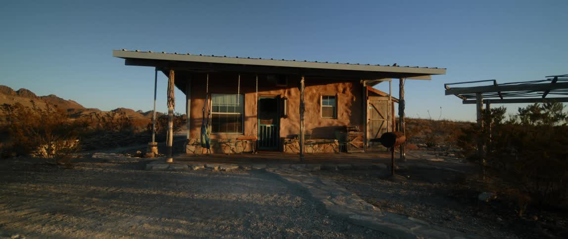 A house in a rural area is displayed at dusk