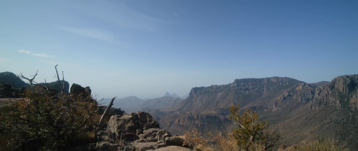The view is of a desert and you can see mountains from the distance