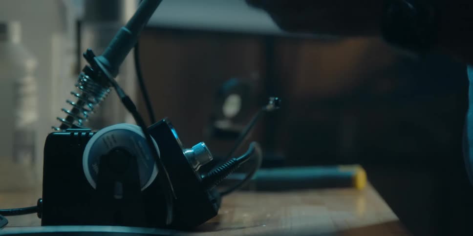 A man in an office puts together electronics