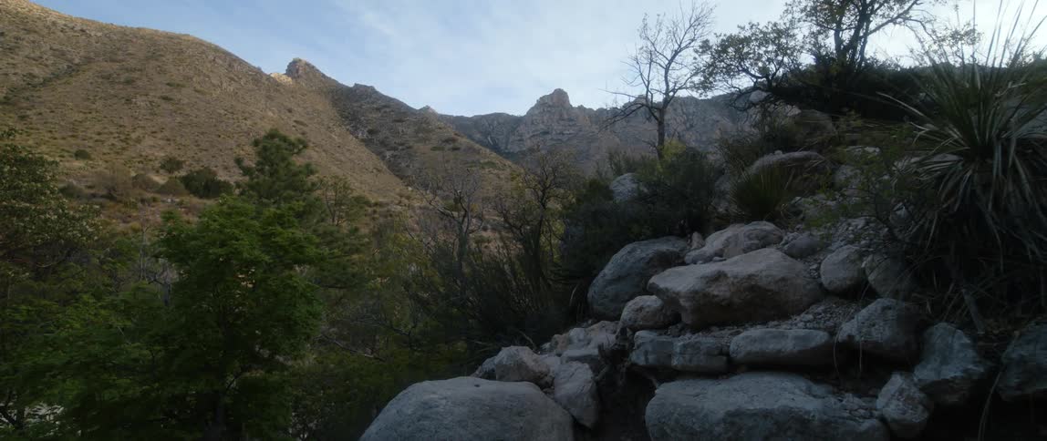 A view of land and mountains are displayed