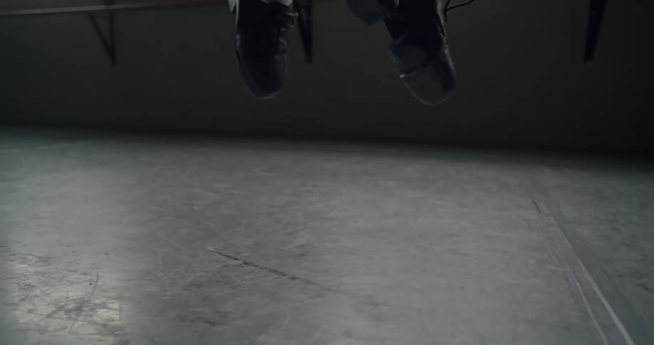 Close up of a ballerinas feet as she jumps in the air