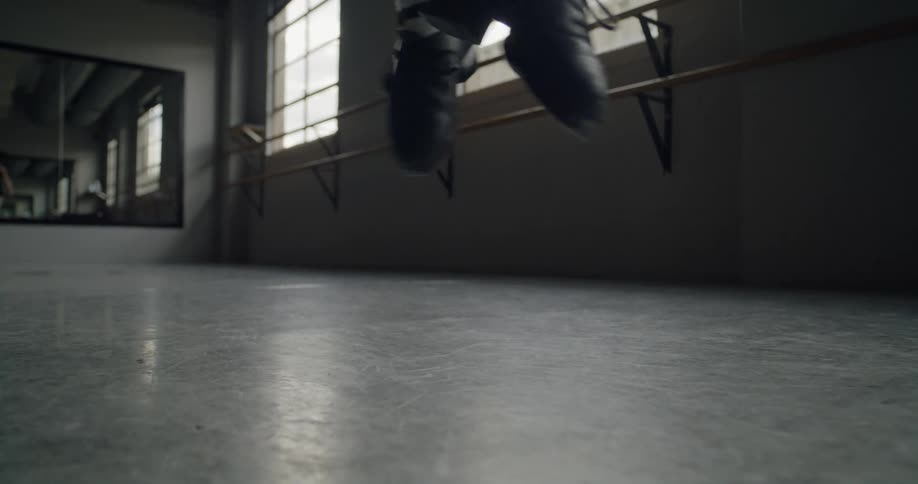 A girl is doing a ballet dance indoors