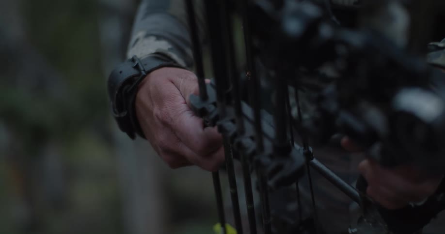 A person using a bow outdoors