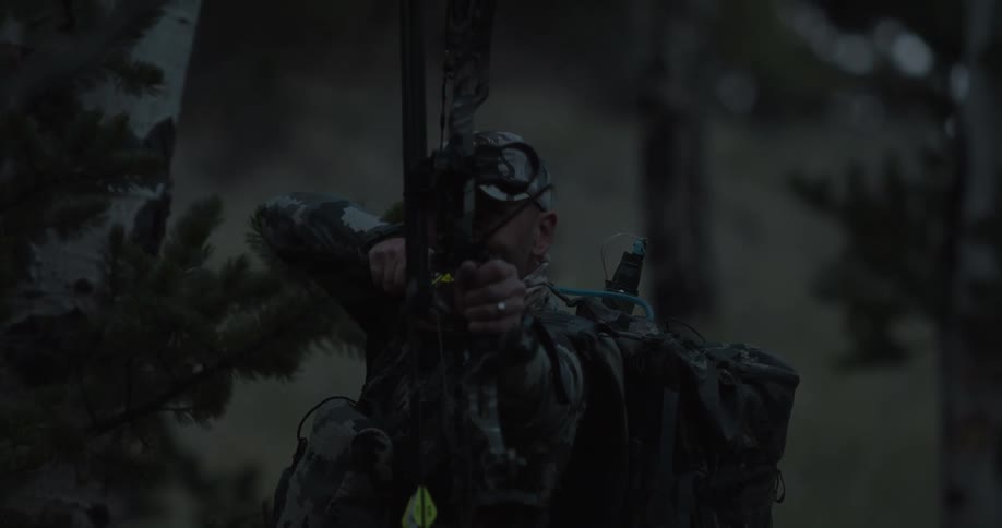 A man with a bow and arrow outdoors