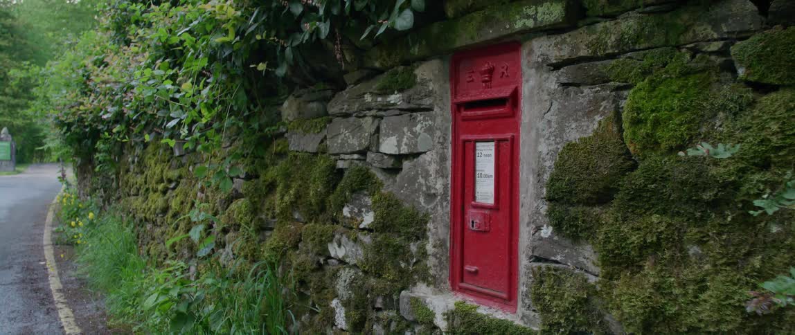 A mailbox on the side of a cliff in a rural area