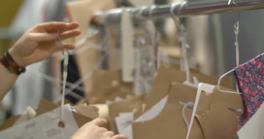 A woman looks through patterns on hangers