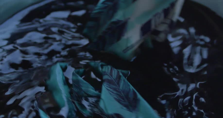 Fabric is dipped and stirred in dye