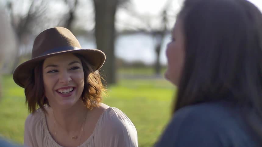 Women talk and laugh in the grass