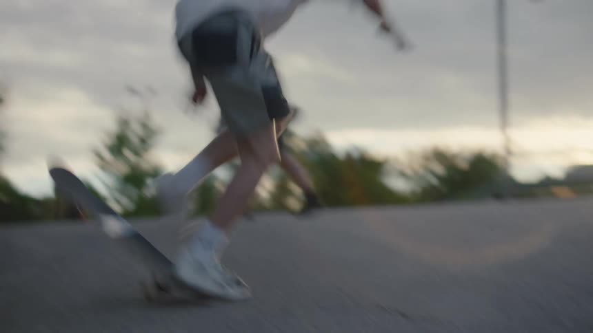 Male skateboarder fails to perform a trick in skatepark