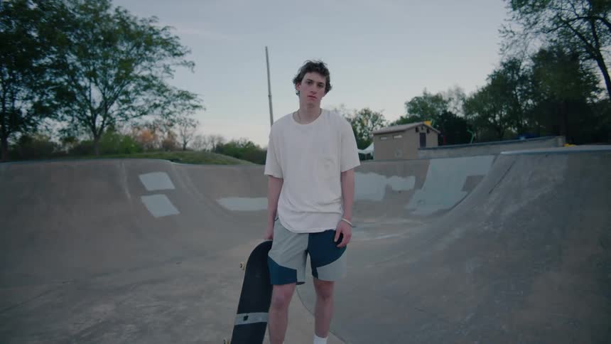Portrait of a teenage boy standing in a skateboard park