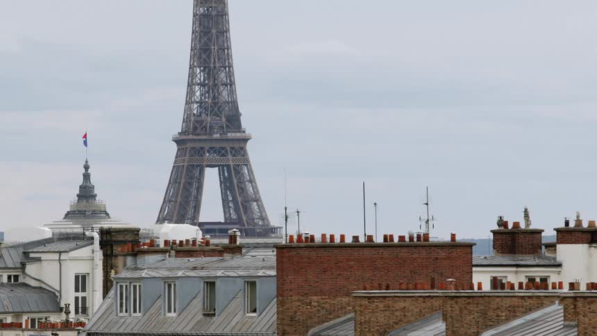 The eiffel tower with a wroughtiron lattice tower on the champ de mars seen from apartment building in paris