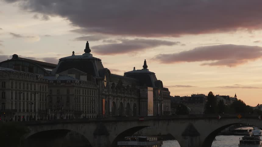 Silhouette of buildings on the city skyline near a river at evening