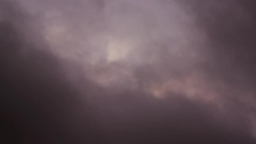 Time lapse of ethereal sunset dream clouds rise and obscure the camera in a perfect credits intro or outro shot