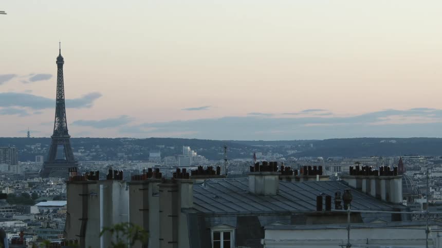 View of eiffel tower and city buildings at dawn