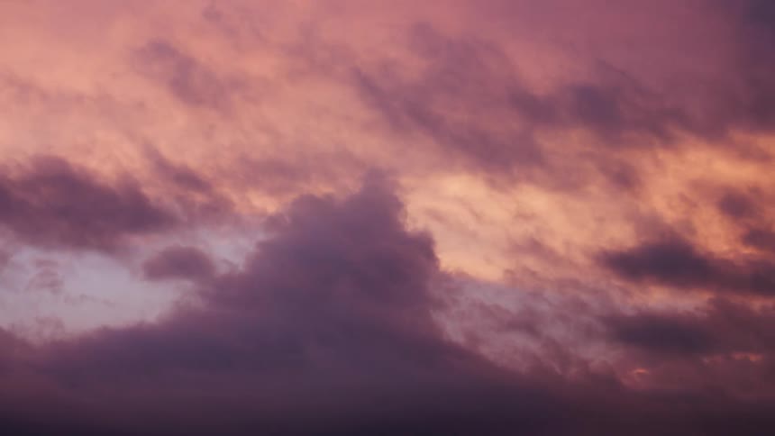 Dreamy and pleasant sunset time lapse of purple, pink and blue storm clouds moving into darkness