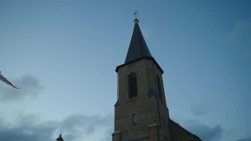 Church tower against the sky at dusk