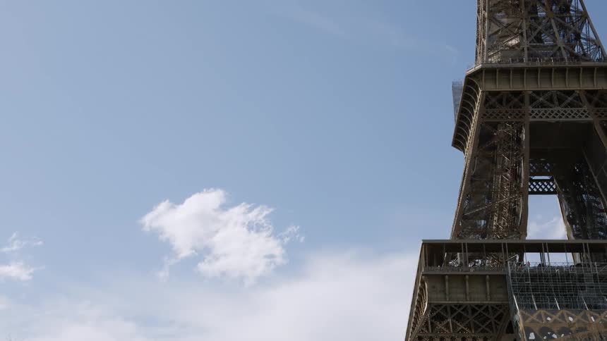 A person climbs up a large steel tower