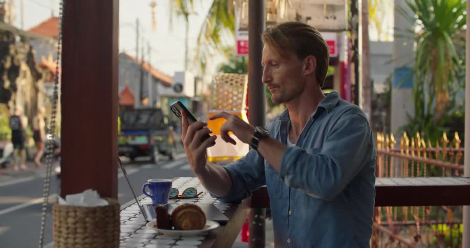 A man is eating lunch at a restaurant during the spring time