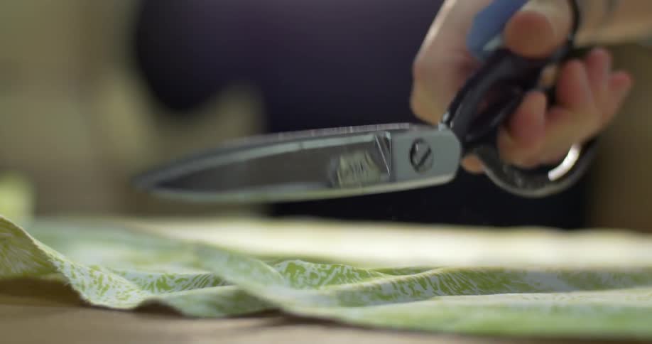 Scissors cut fabric on a table