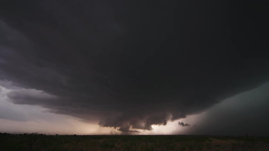 Severe storm time lapse with huge lightning bolts as the massive rotating supercell storm creates perfect visual contrast on the left and right side of the frame