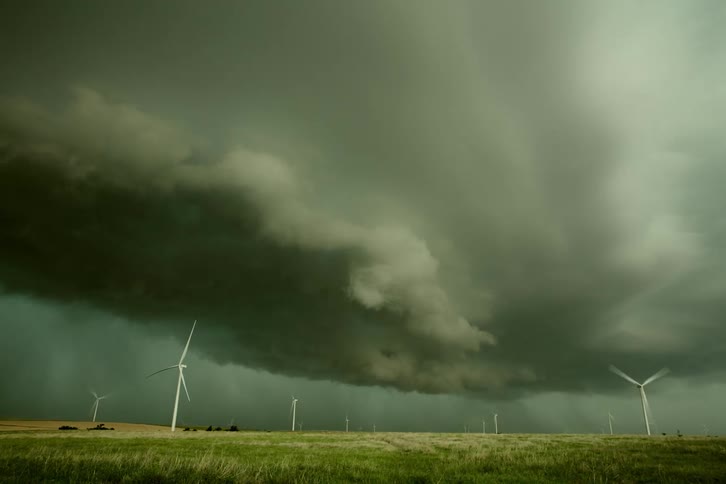Time lapse of wind turbines spinning under super cell rolling and rotating storm clouds in the midwest, USA