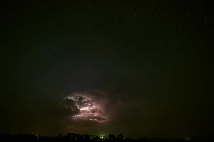 Time lapse of lightning flashing in dark supercell storm clouds as they move across the sky