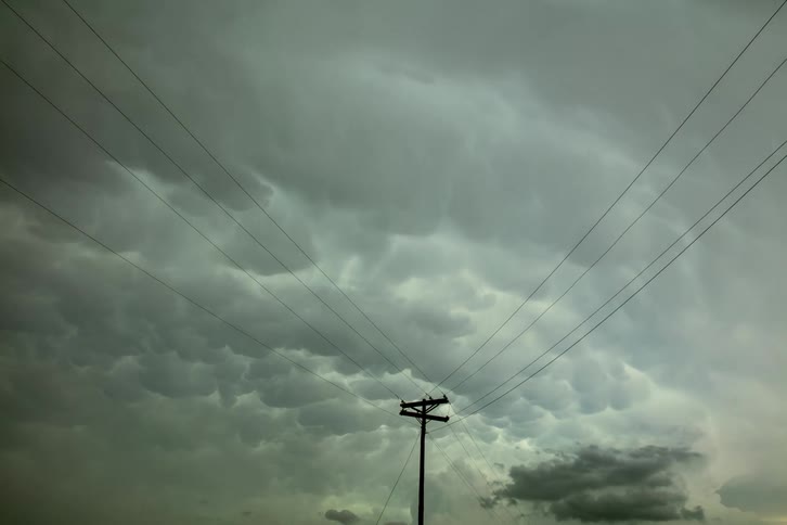 Timelapse of Mammatus clouds and massive thunderstorm building framed by powerlines