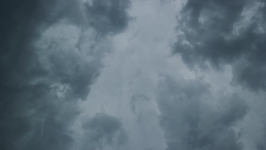 Time lapse of severe storm clouds pushing rapidly over the camera communicating intensity and urgency
