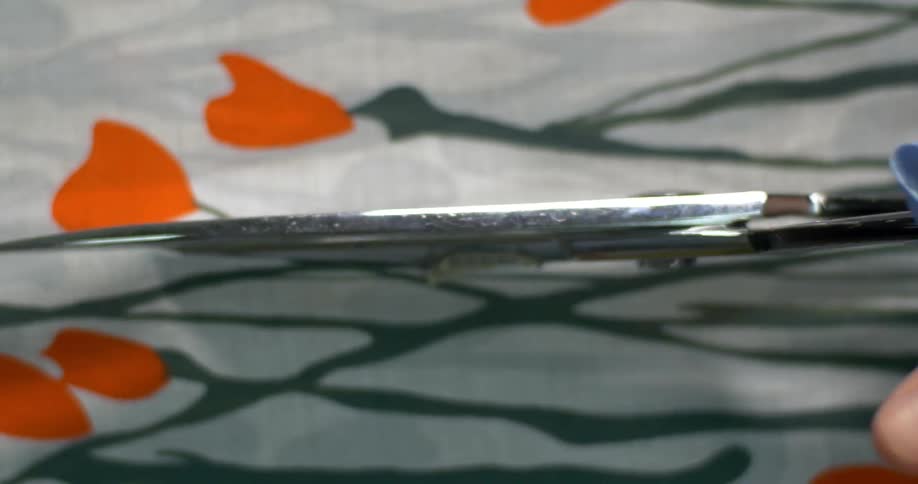 A woman using scissors to cut through fabric